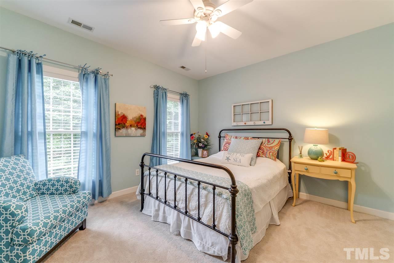 1701 Crown Glenn Place Raleigh, NC 27613 - Photo 21 of 25 a bedroom with a bed and a chandelier