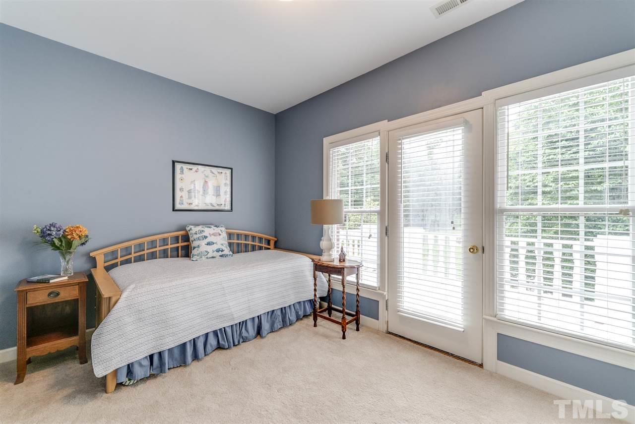 1701 Crown Glenn Place Raleigh, NC 27613 - Photo 22 of 25 a bedroom with a bed and a table