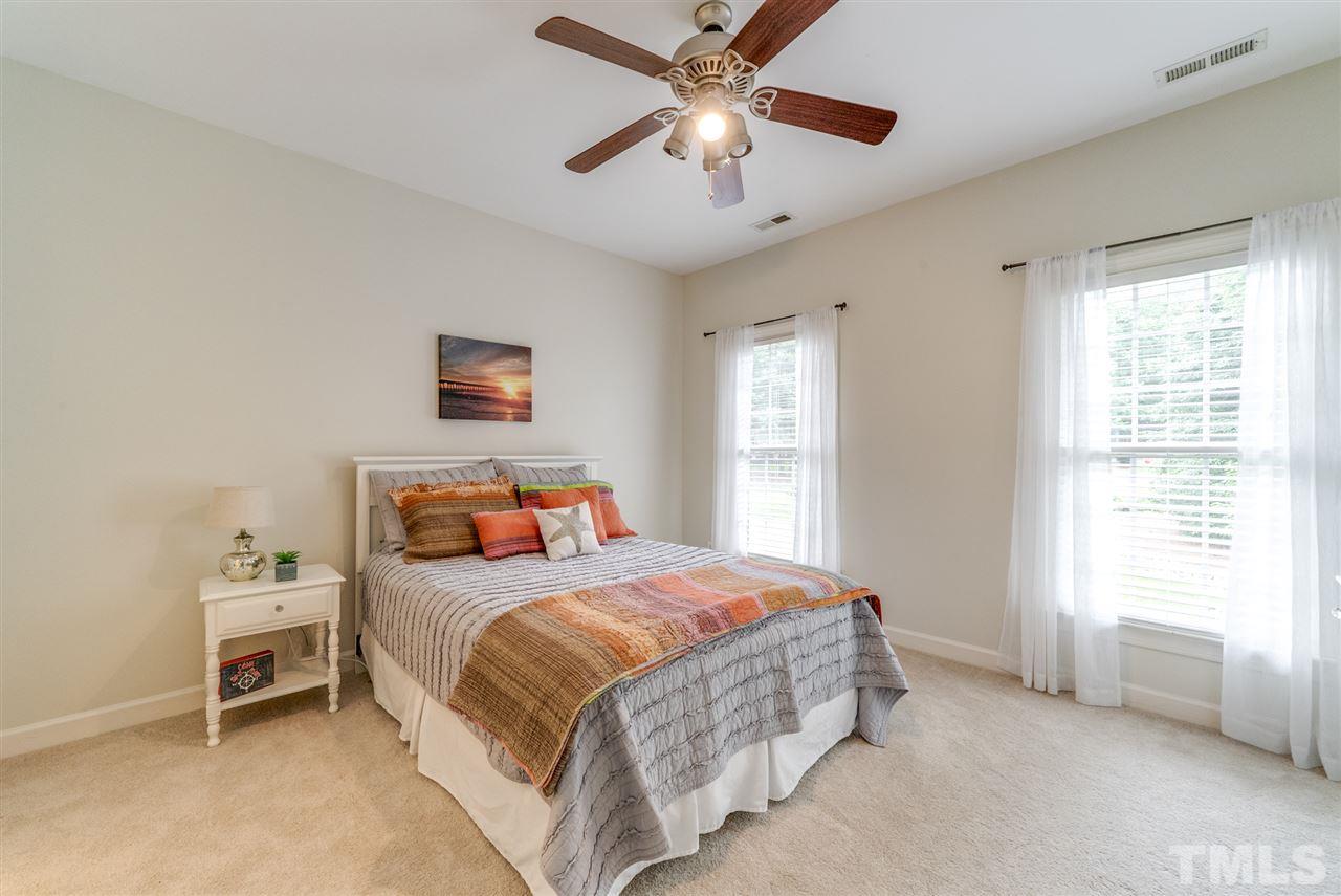 1701 Crown Glenn Place Raleigh, NC 27613 - Photo 24 of 25 a bedroom with a bed and a window
