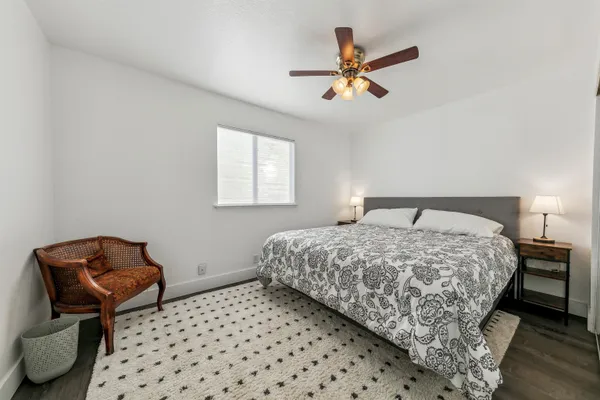 a bedroom with a bed and chair