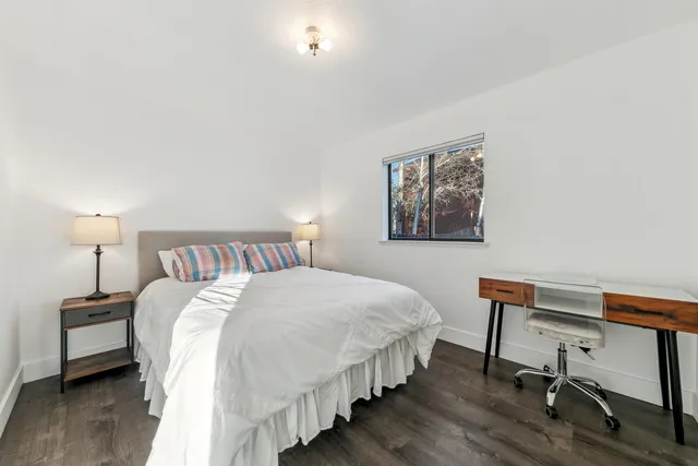 a bedroom with bed and a desk