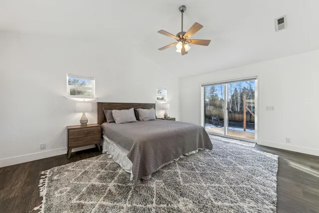 a bedroom with a large bed and a chandelier