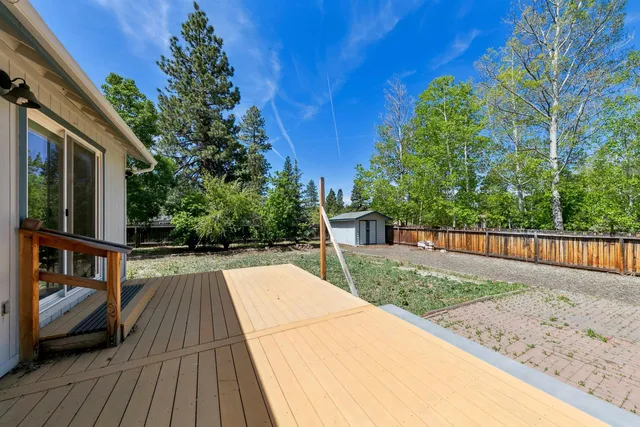 a view of balcony with wooden floor and fence