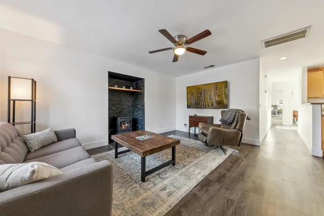 a living room with furniture wooden floor and window