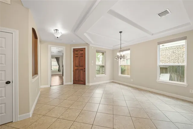 a view of an empty room with glass door