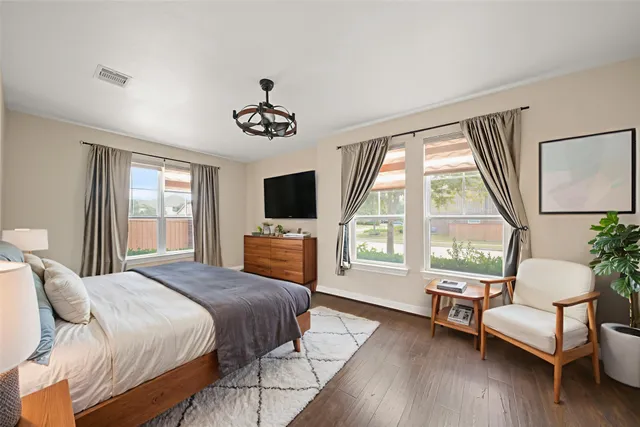 a bedroom with a bed and a chair