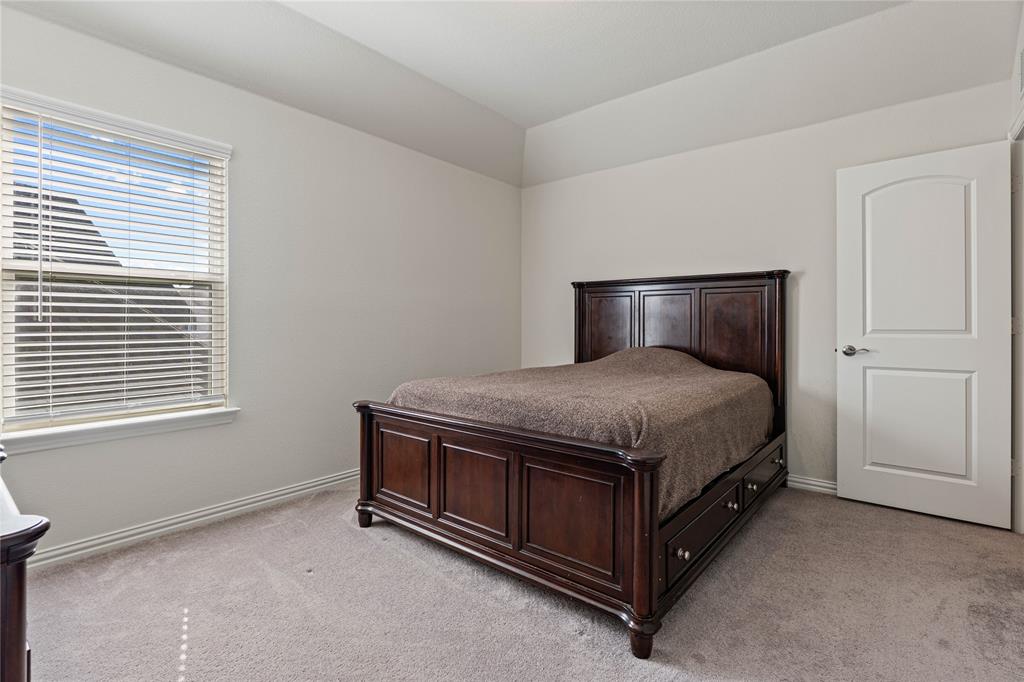 9517 Sunset Lane Oak Point, TX 75068 - Photo 36 of 40 9517 Sunset Lane, Oak Point, TX 75068 - bedroom - Bedroom featuring light carpet and vaulted ceiling