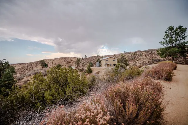 an aerial view of house with a mountain