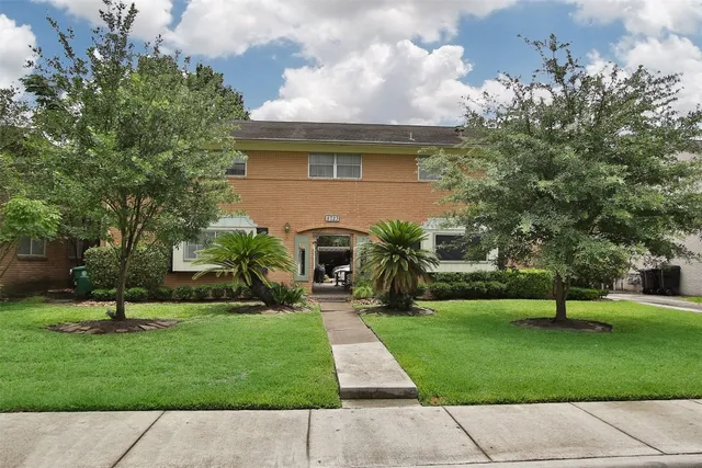 a view of a path with potted plants