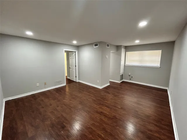 a view of a kitchen with wooden floor and a sink
