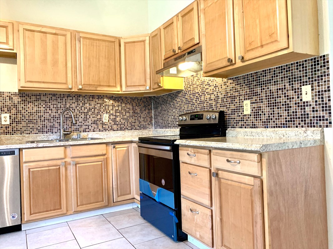 14-3404 Hawaii Road Pahoa, HI 96778 - Photo 4 of 22 a kitchen with granite countertop white cabinets and sink