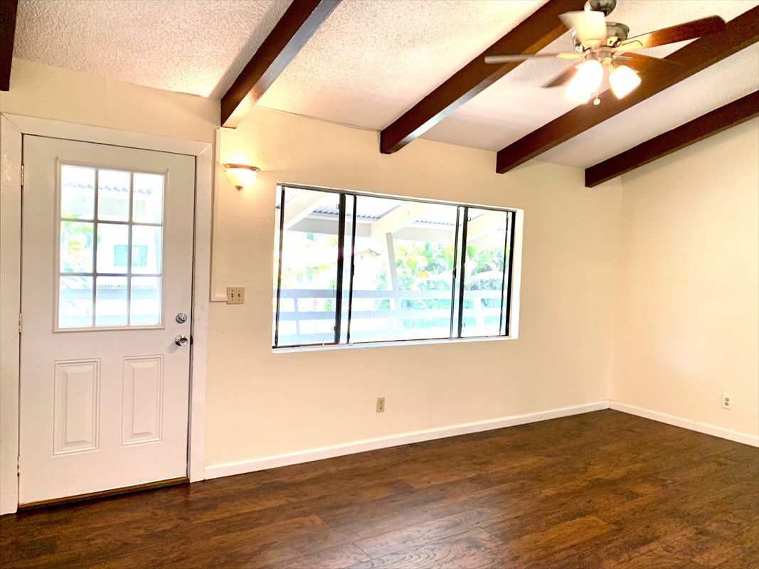 14-3404 Hawaii Road Pahoa, HI 96778 - Photo 6 of 22 a view of an empty room with wooden floor and a window