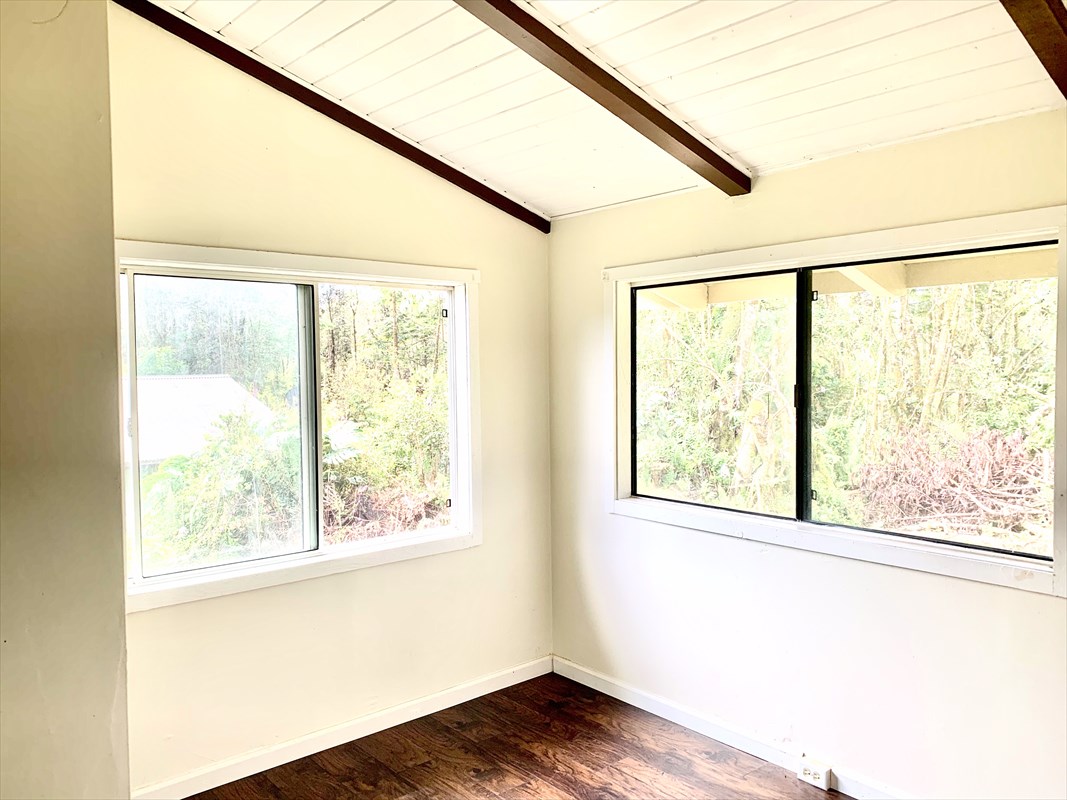 14-3404 Hawaii Road Pahoa, HI 96778 - Photo 9 of 22 a view of an empty room with wooden floor and a window