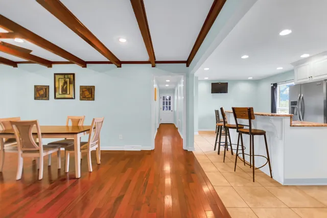 a dining room with furniture and wooden floor
