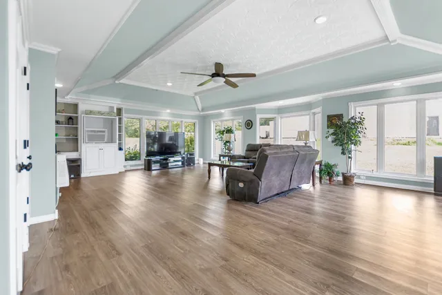 a living room with furniture and wooden floor
