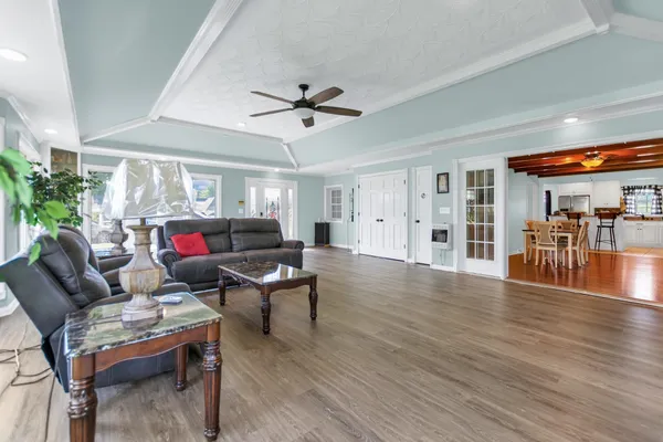a living room with furniture and wooden floor