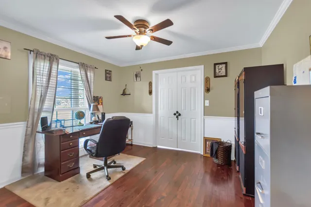 a view of a workspace with furniture and a window