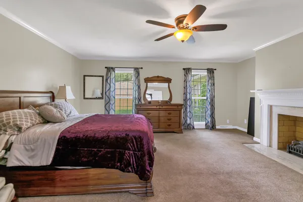 a bedroom with a bed and a fireplace