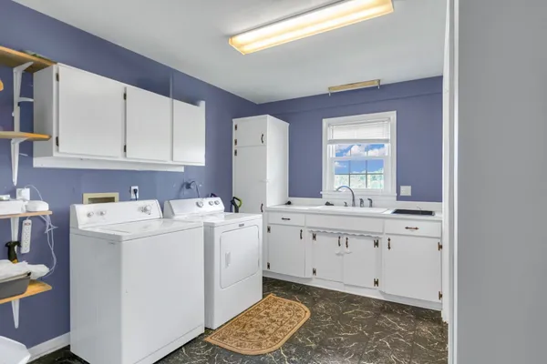 a kitchen with a sink cabinets and window