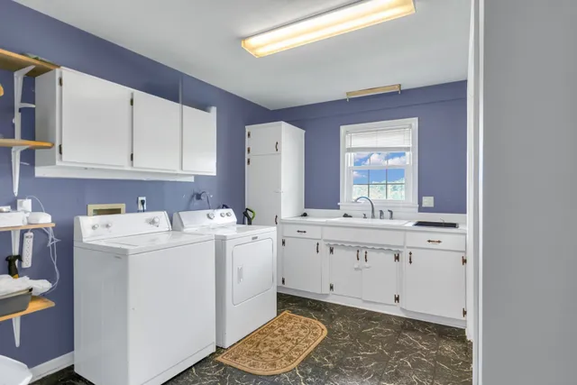 a kitchen with a sink cabinets and window