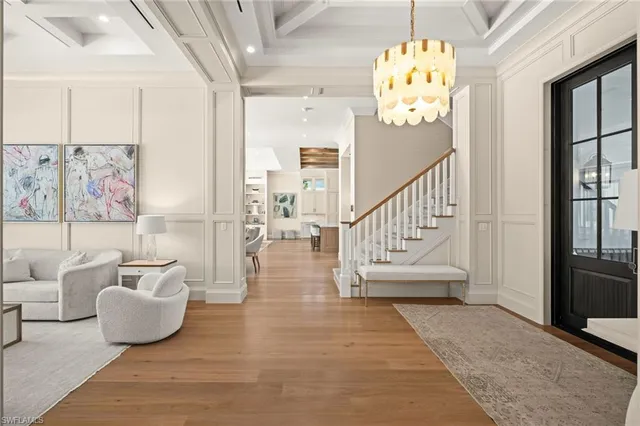 a view of a dining room with furniture wooden floor and chandelier