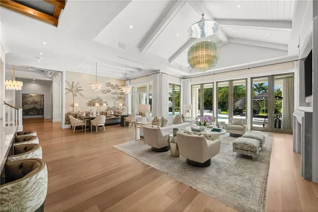 a living room with furniture and a chandelier