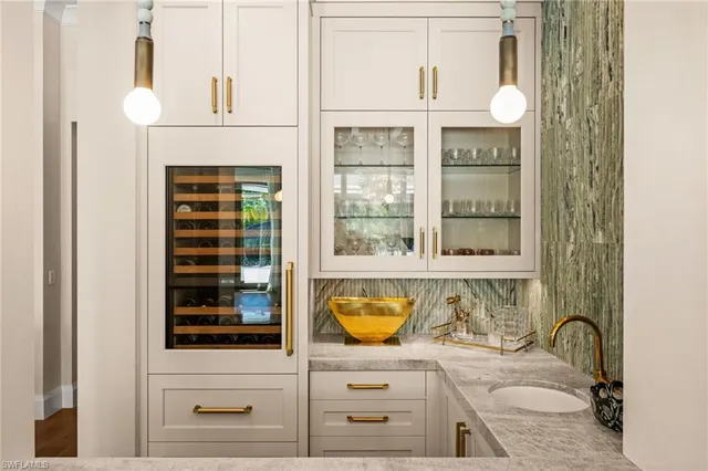 a bathroom with a granite countertop double vanity and mirror