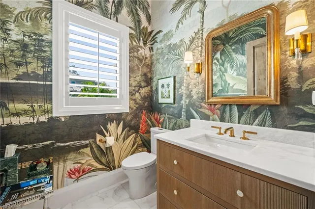 a bedroom with a bed chandelier and a window