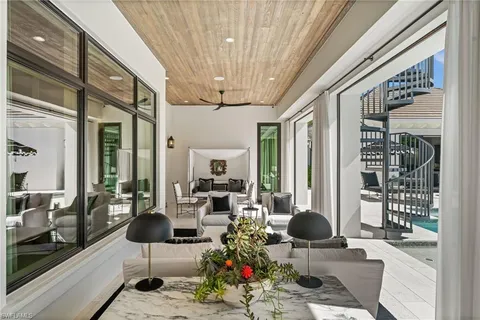 a vase of flowers sitting on a floor in front of a door