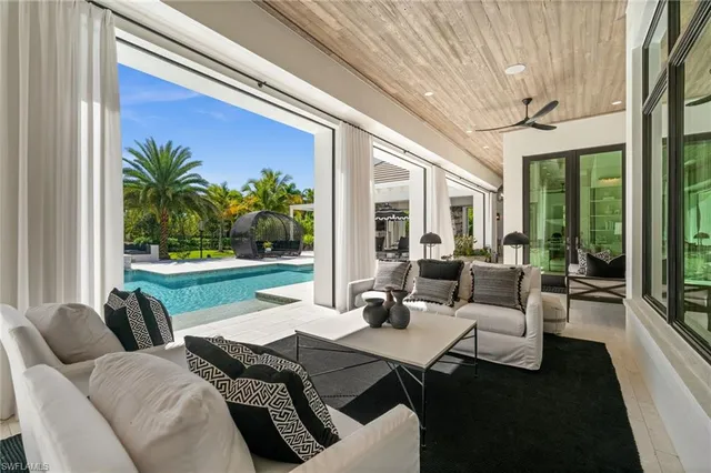 a dining room with furniture and a large window