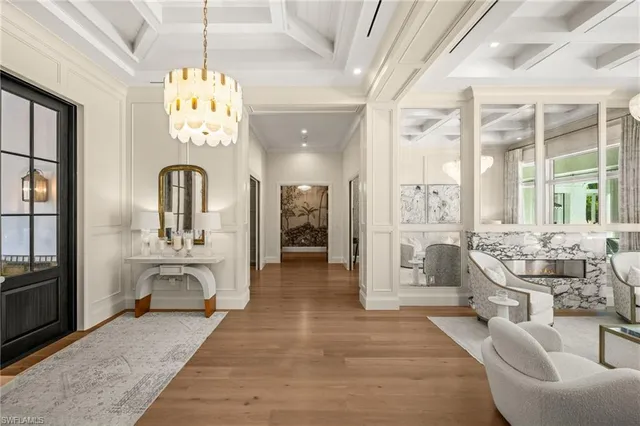 a very nice looking room with a large window and chandelier