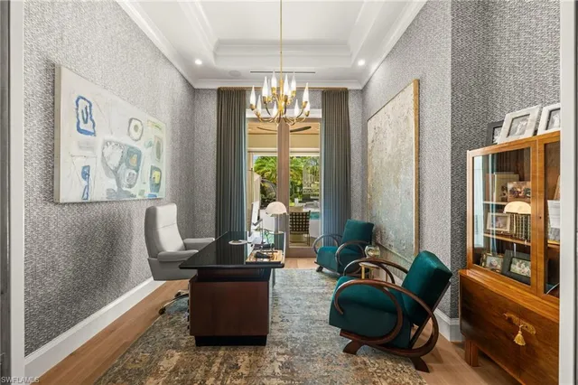 a living room with furniture and a chandelier