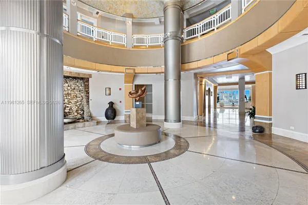 a view of a lobby with furniture and a chandelier