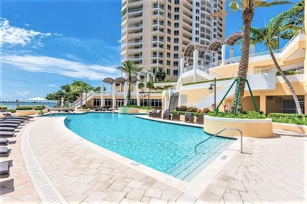 a view of swimming pool with outdoor seating and city view
