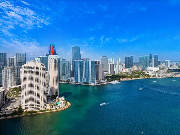 a view of a ocean with residential apartment building in the background