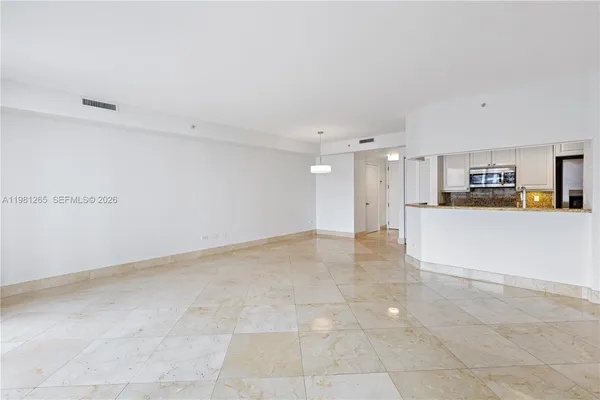 a view of a kitchen with furniture and an empty space