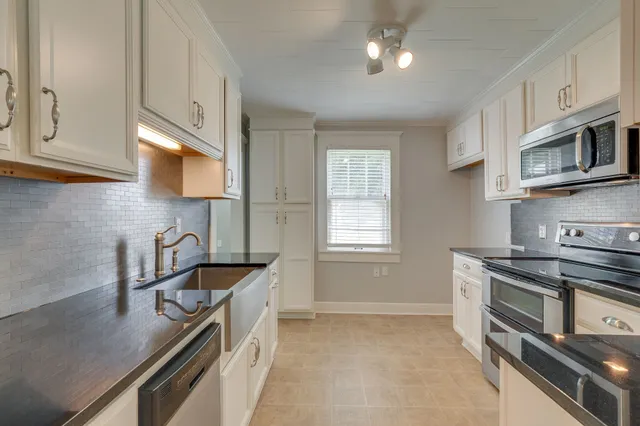 a kitchen that has a sink and a stove