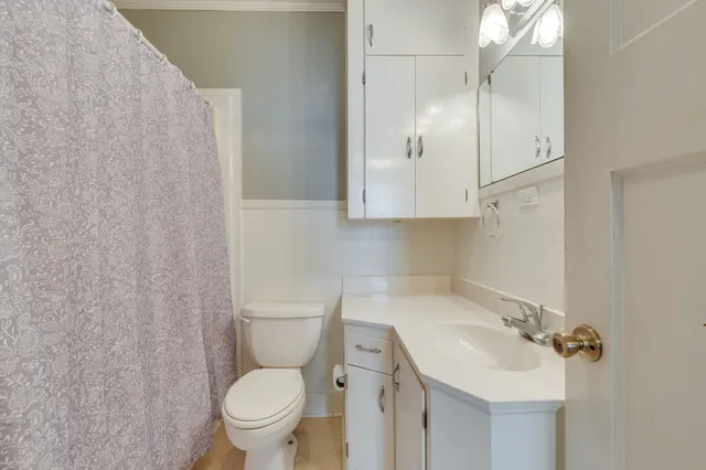 a bathroom with a sink toilet and a mirror
