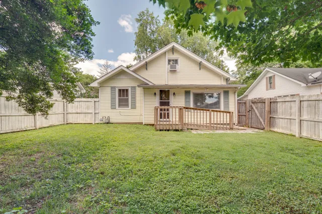 a view of a house with a yard and a garden