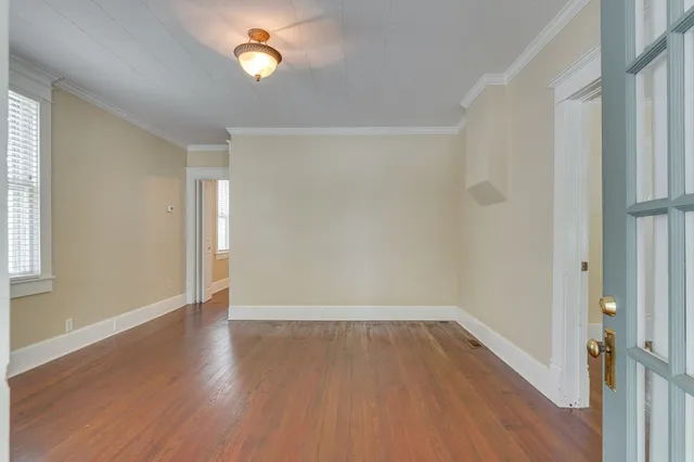 wooden floor in an empty room with a window