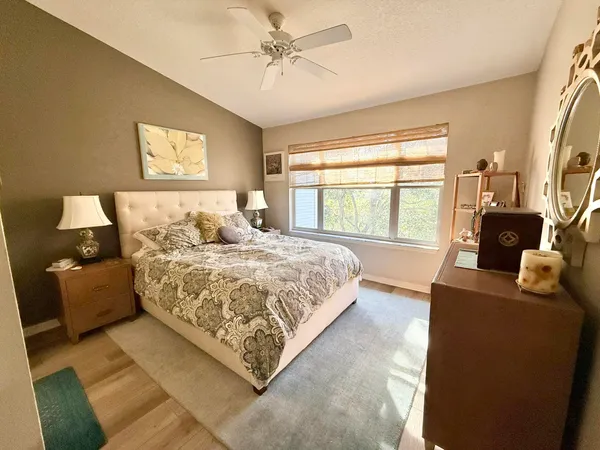 a bedroom with a large bed couch and a window