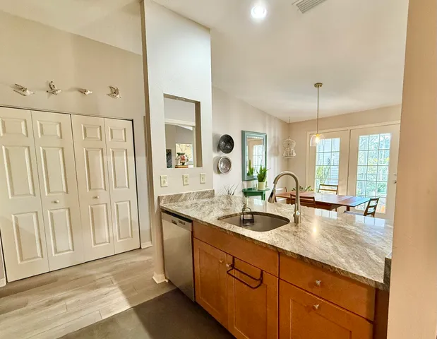 a spacious bathroom with a granite countertop sink a mirror a and a window