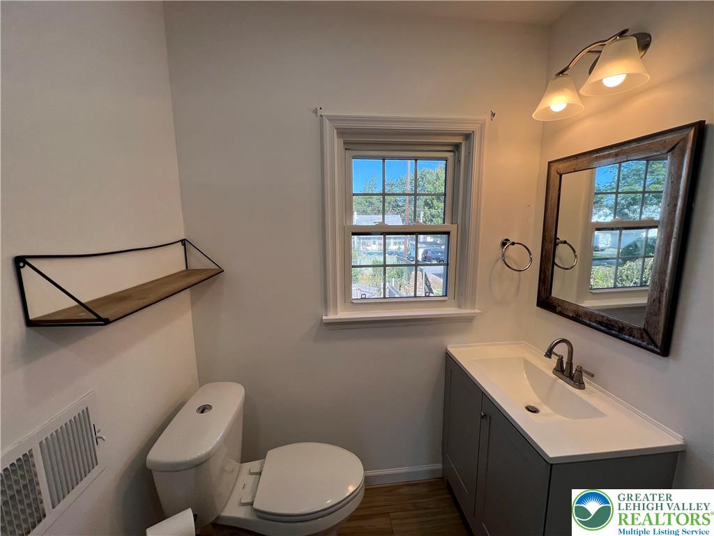 135 West Wabash Street Allentown, PA 18103 - Photo 11 of 69 a bathroom with a sink vanity mirror and toilet