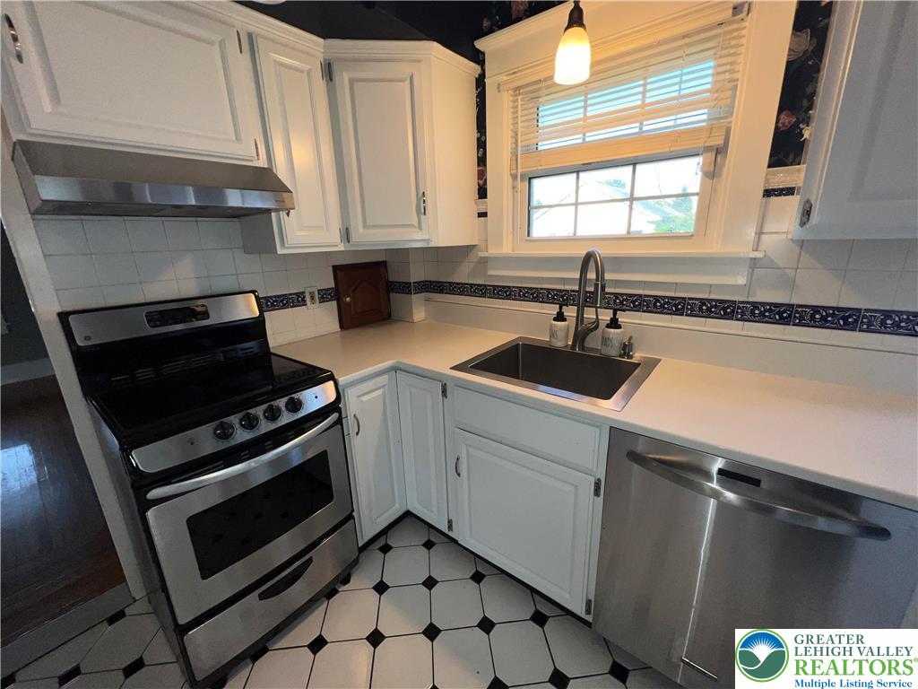 135 West Wabash Street Allentown, PA 18103 - Photo 7 of 69 a kitchen with a sink stove top oven and cabinets