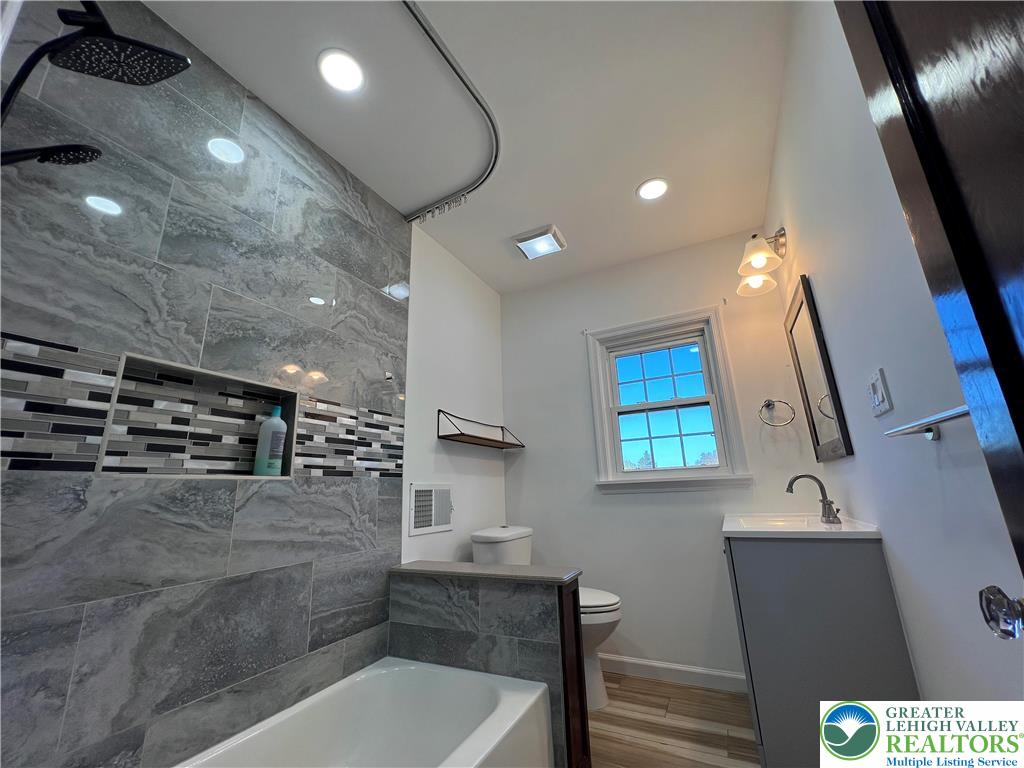 135 West Wabash Street Allentown, PA 18103 - Photo 10 of 69 a bathroom with a sink a toilet and a mirror