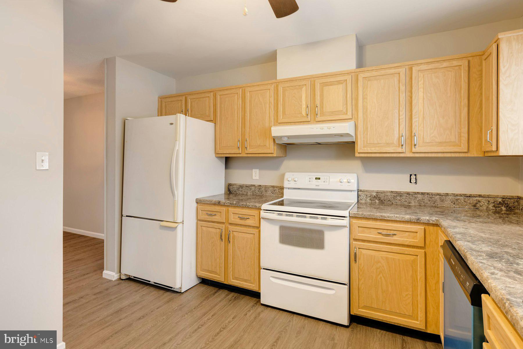 2105 Old Landing Way Woodbridge, VA 22191 - Photo 14 of 30 a kitchen with white cabinets and white appliances
