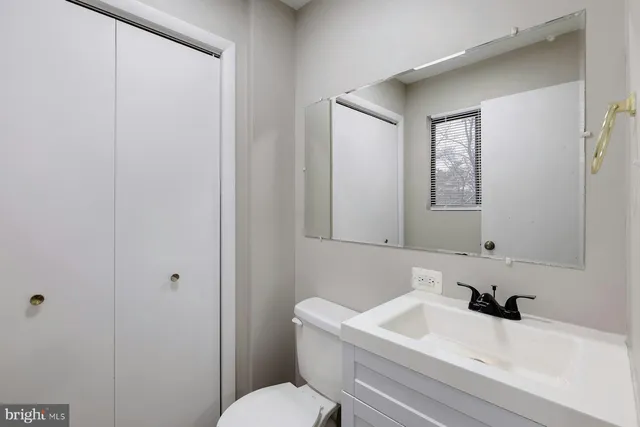 a bathroom with a sink a toilet and a mirror