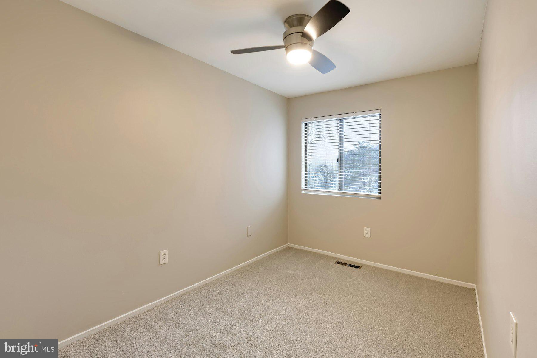 2105 Old Landing Way Woodbridge, VA 22191 - Photo 21 of 30 an empty room with a window and a ceiling fan