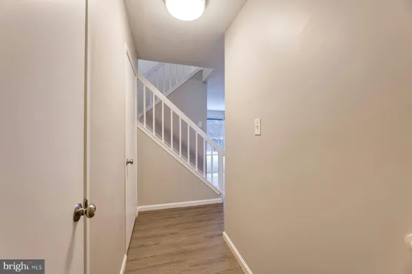 a view of a hallway with wooden floor and entryway