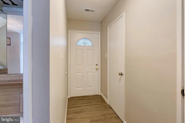 a view of a hallway with wooden floor